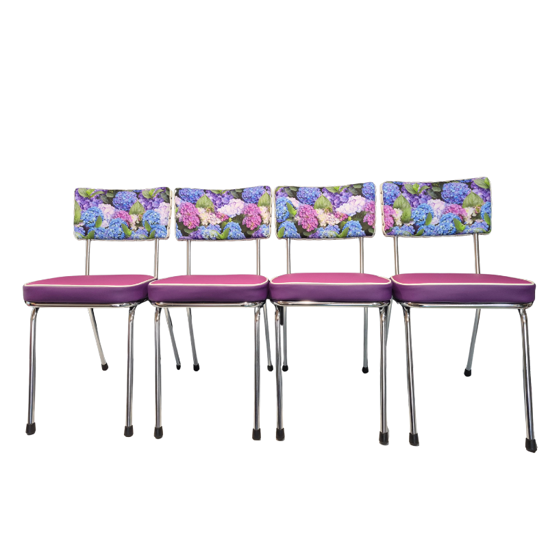 Four matching dining chairs with purple upholstered seats and hydrangea floral-patterned backrests, shown against a plain white background.