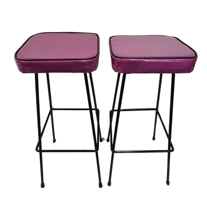 Two purple bar stools with black metal frames on a white background