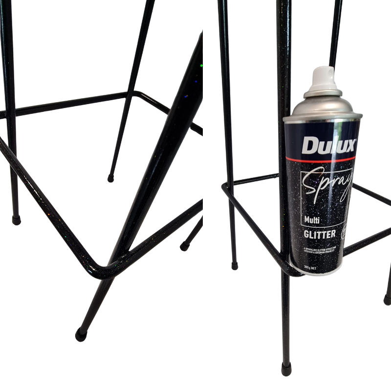 Dulux spray paint can on a black metal stand with a white background
