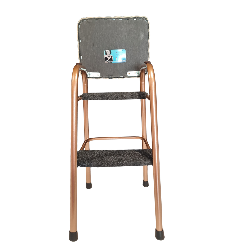A two-step ladder stool with a metallic copper/rose gold frame and dark gray textured fabric on the steps and backrest, shown against a plain white background.