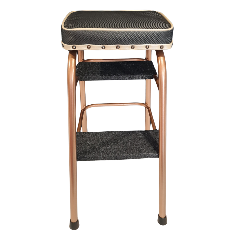 A two-step stool with a textured black seat cushion and two lower steps, featuring a copper-colored metal frame and decorative brass-tone rivets on the seat apron.