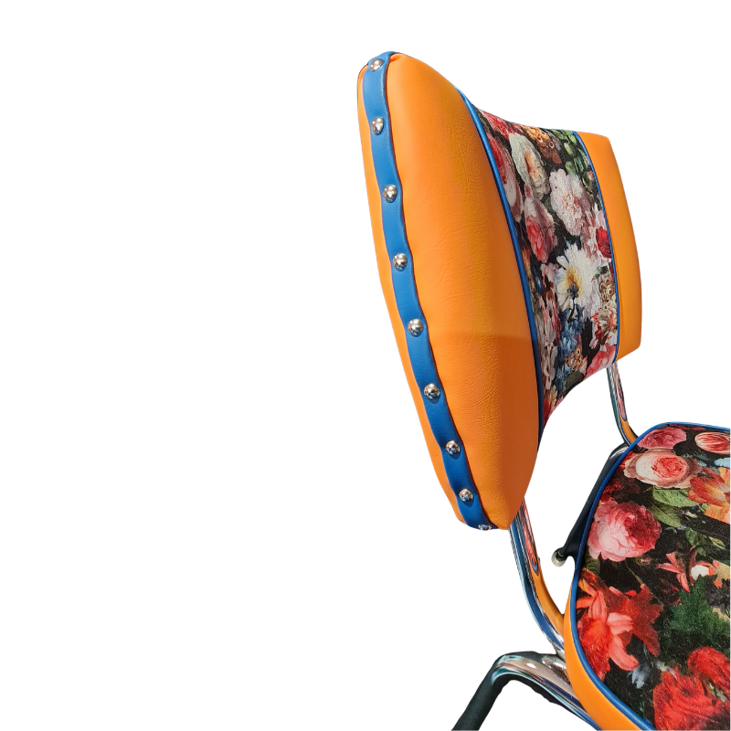 Colorful chair with floral patterns and blue accents on a white background