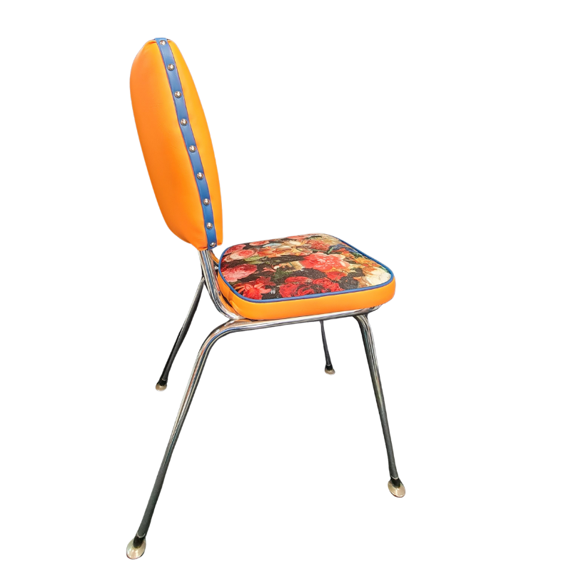 Vintage-style chair with orange backrest and floral seat on a white background