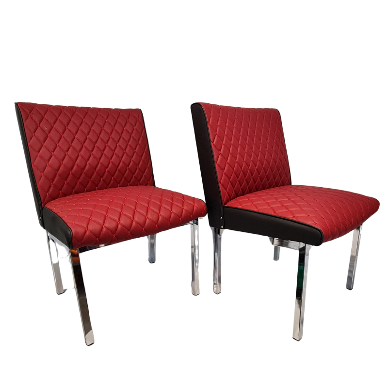 Two burgundy quilted chairs with black accents on a white background