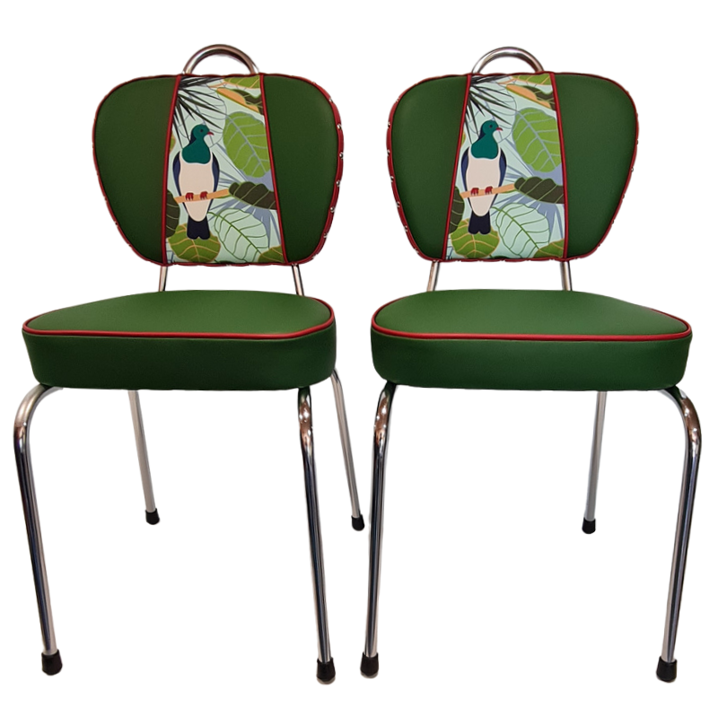 Two green chairs with patterned kereru backrests on a white background