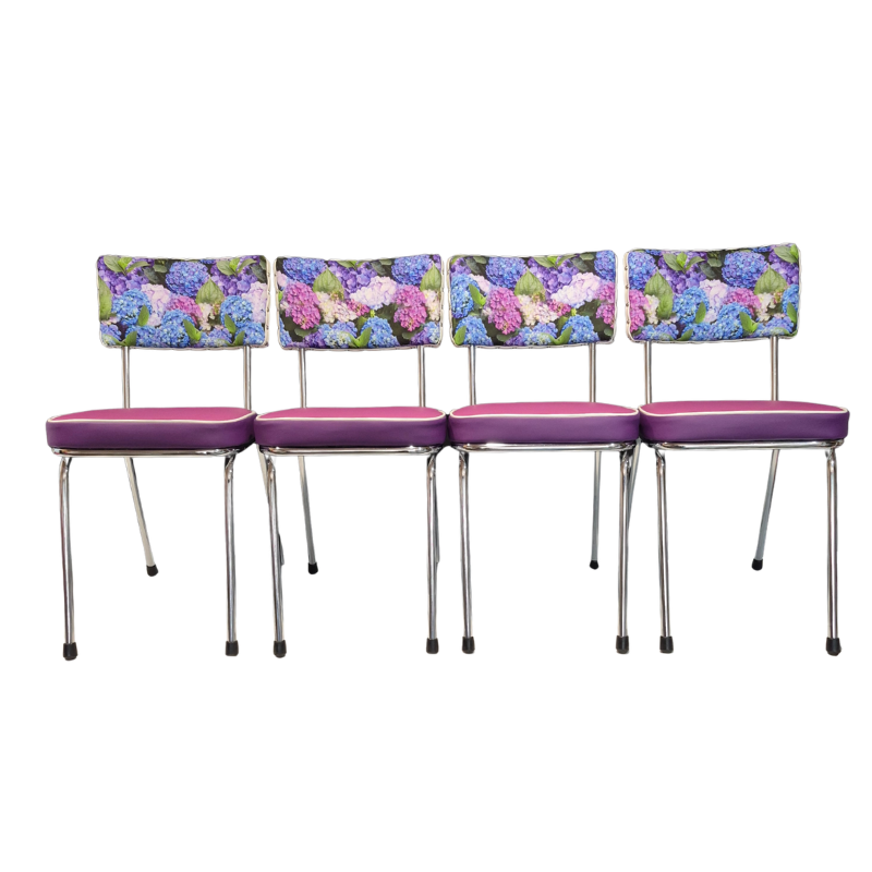 Four matching dining chairs with hydrangea floral backrests and purple-pink padded seats, shown side by side on a plain white background.