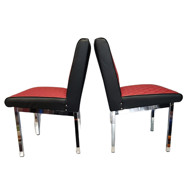 Two black boarders chairs with burgundy seats on a white background